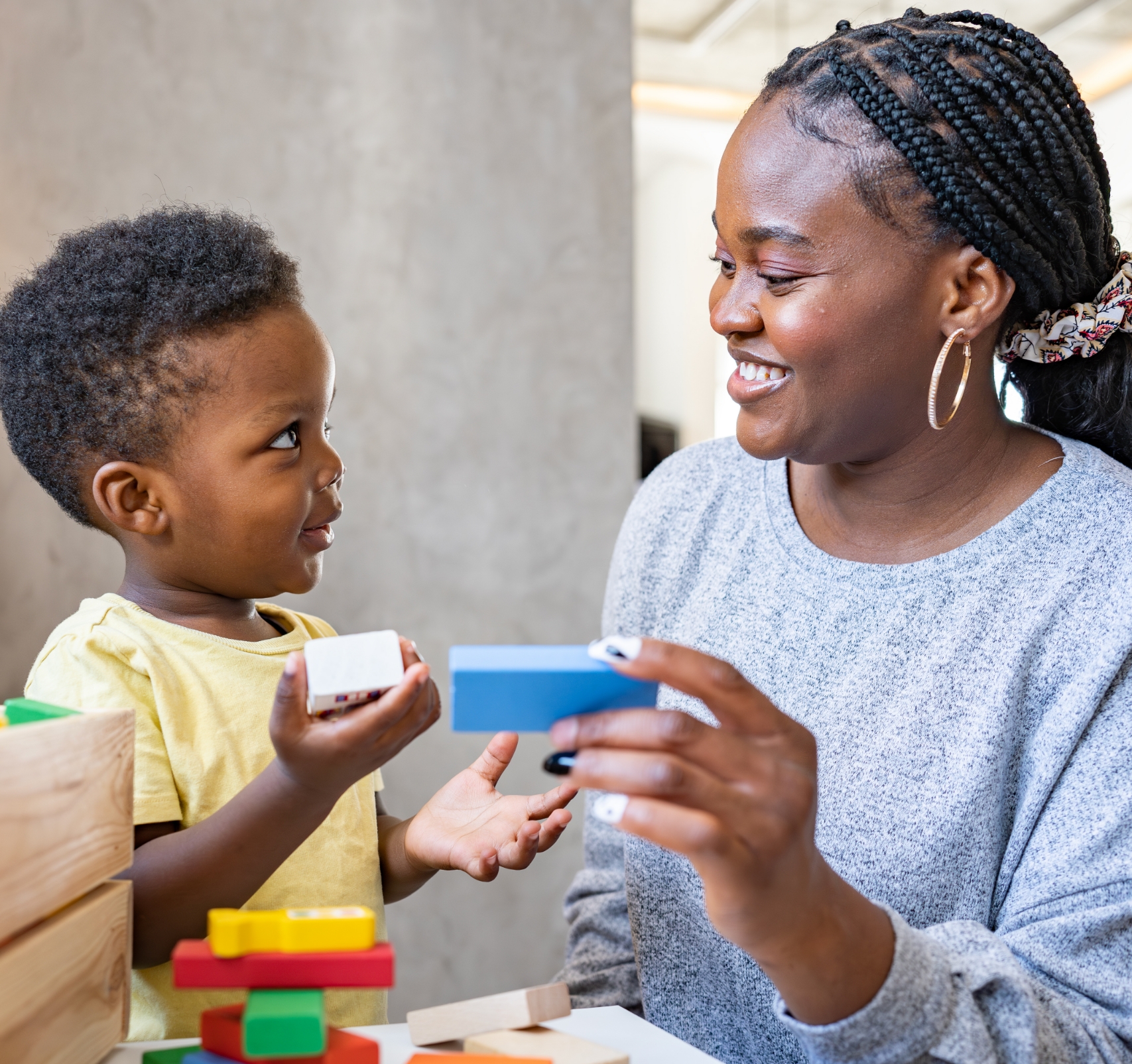 Child and parent holding blocks